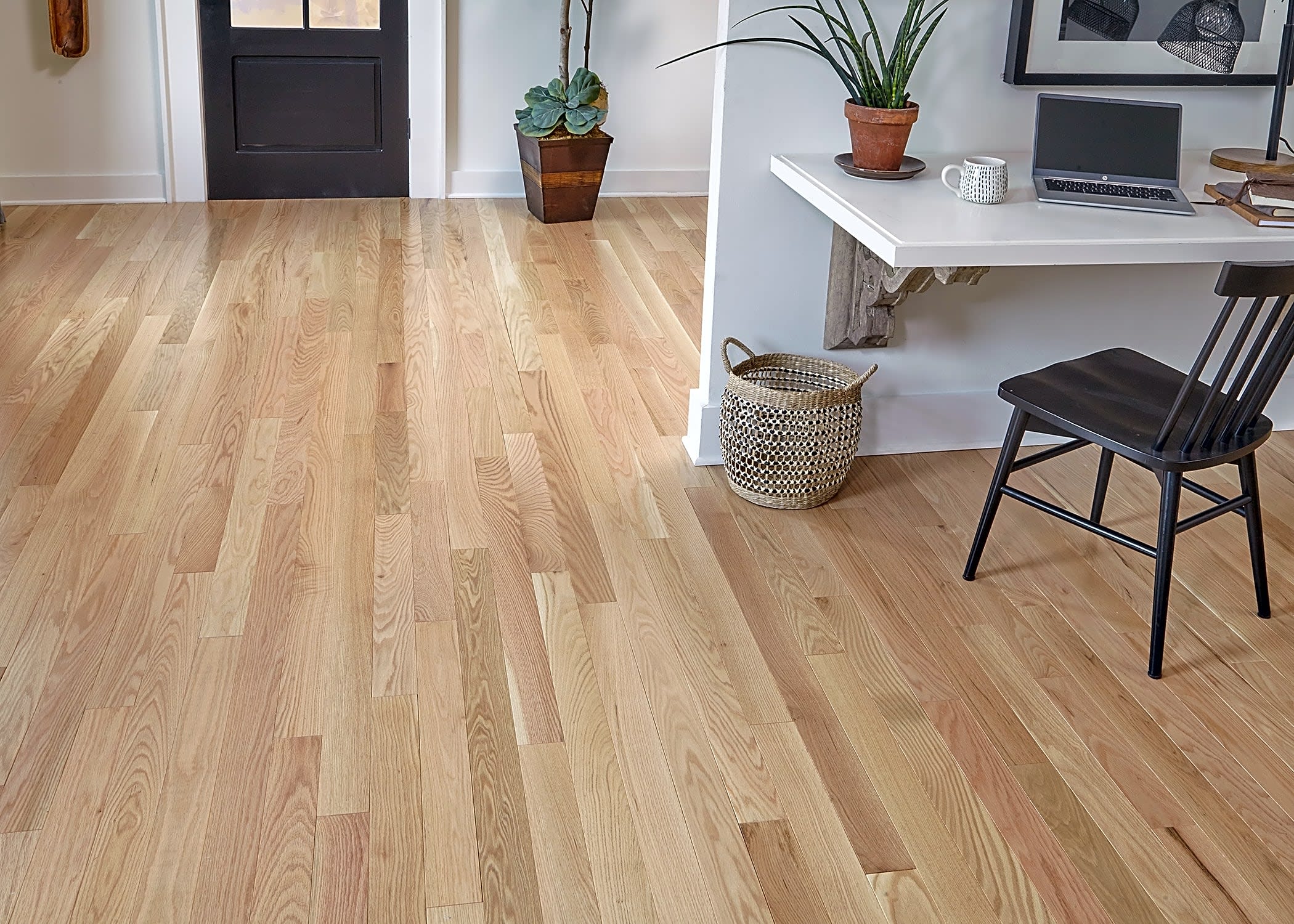 A wall shelf can be multifunction if used as a desk surface. This home features classic Bellawood Character Grade Red Oak solid hardwood flooring.