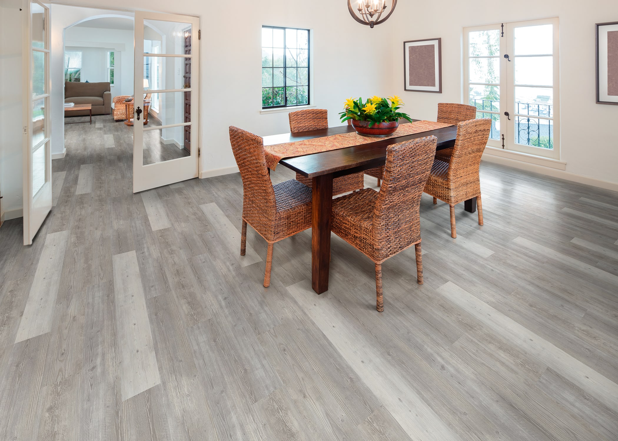 French doors connect this bright dining room and living room, with Mont-Blanc Pine RVP Flooring.