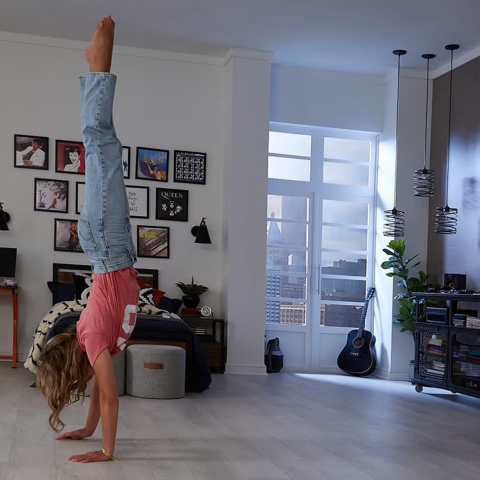 woman does a handstand on new laminate flooring