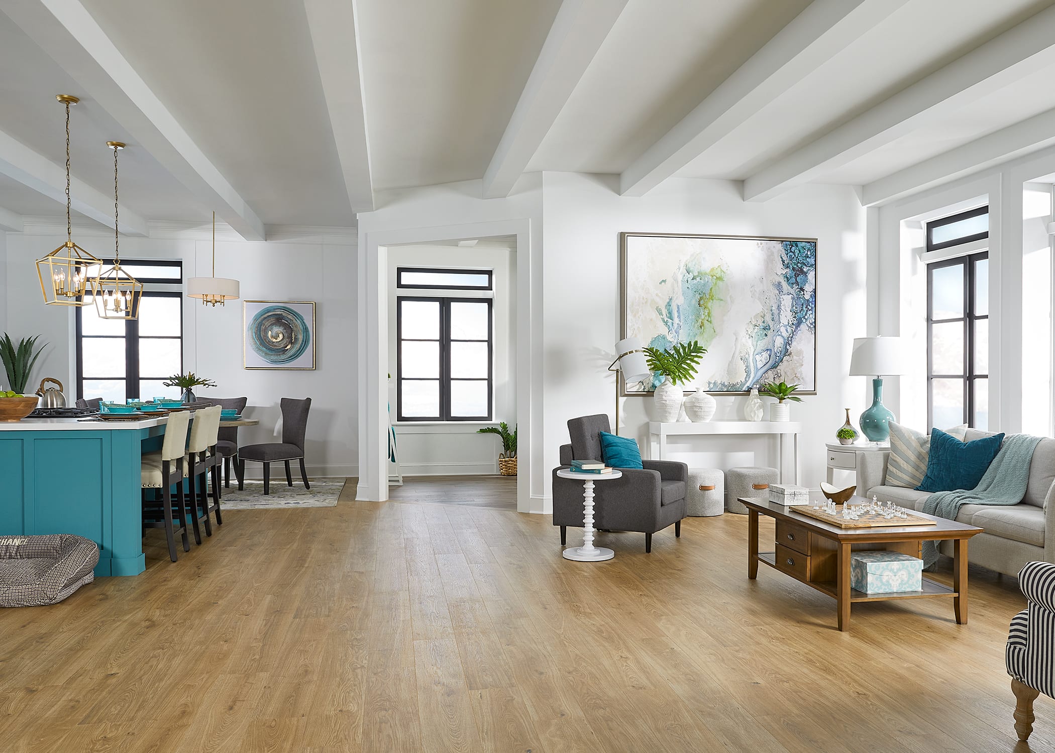 This bright, open living space features Duravana Bay Bridge Oak Waterproof Hybrid Resilient Flooring.