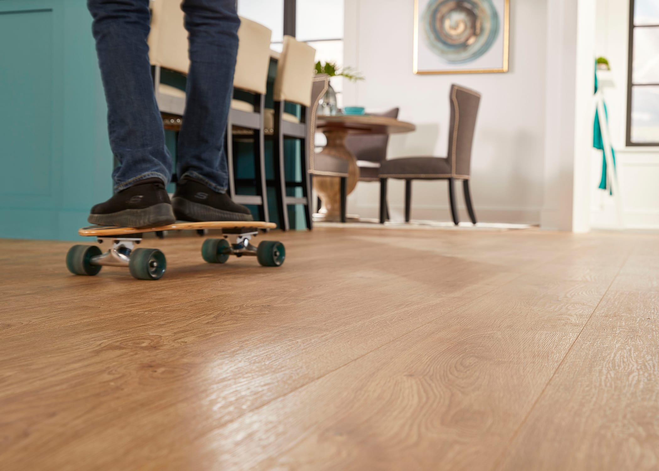 Man rides a skateboard in the living room on Duravana Eco-friendly flooring