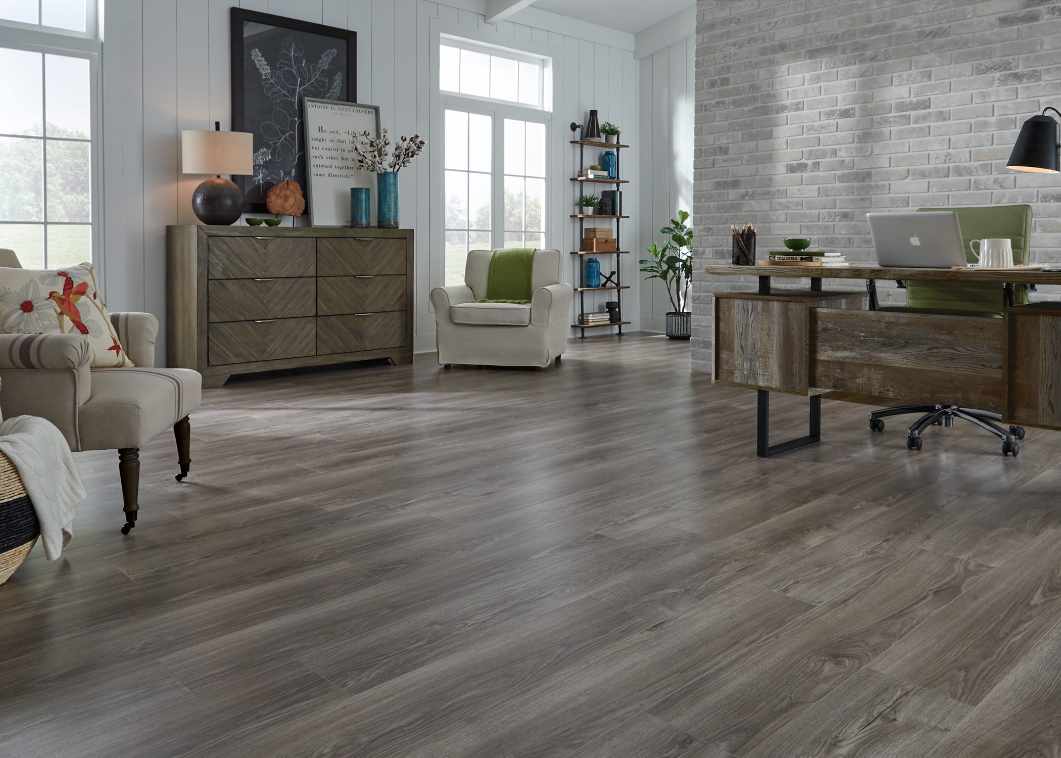 Room with chairs and gray wood waterproof laminate flooring.