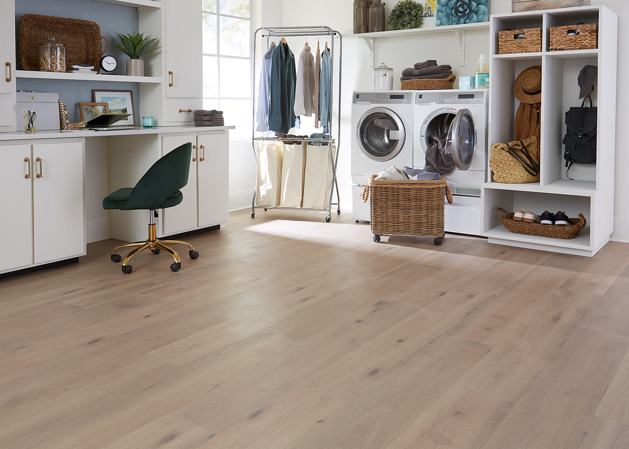 mudroom with hanging rack and storage shelves around laundry with desk work station