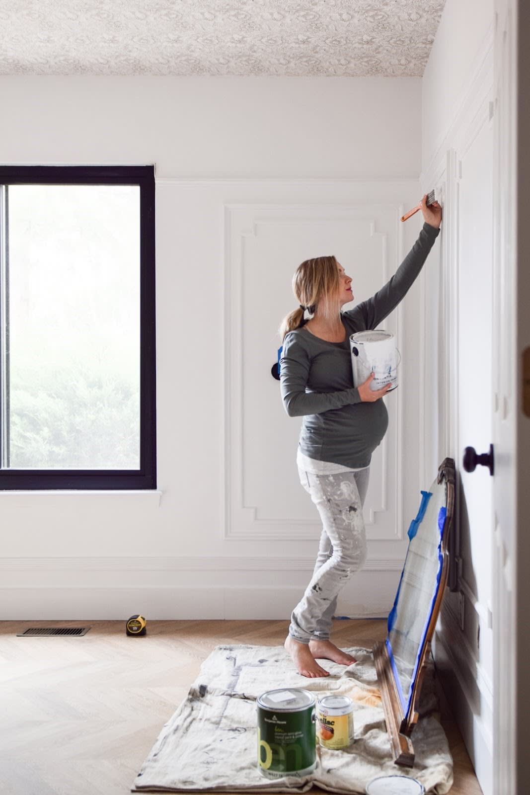 Cait Pappas paints walls of the new nursery for @NestOutWest