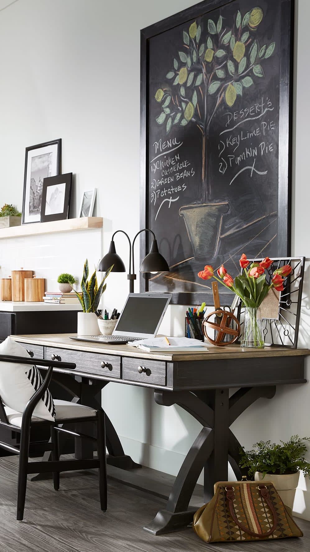 This entryway uses a desk and large chalkboard to become a command center for the home