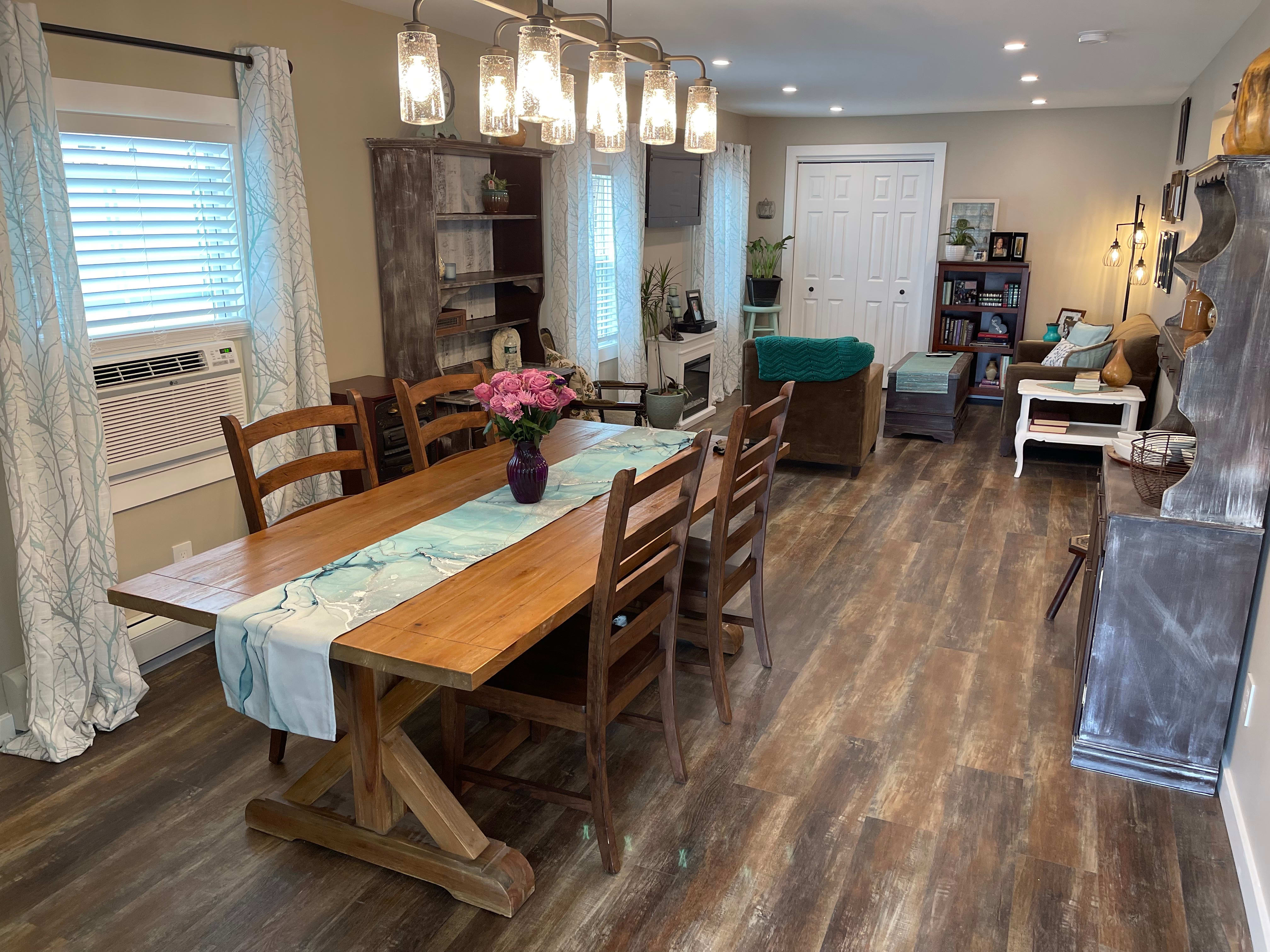 The dining and living room with rustic chic decor and waterproof rigid vinyl plank flooring