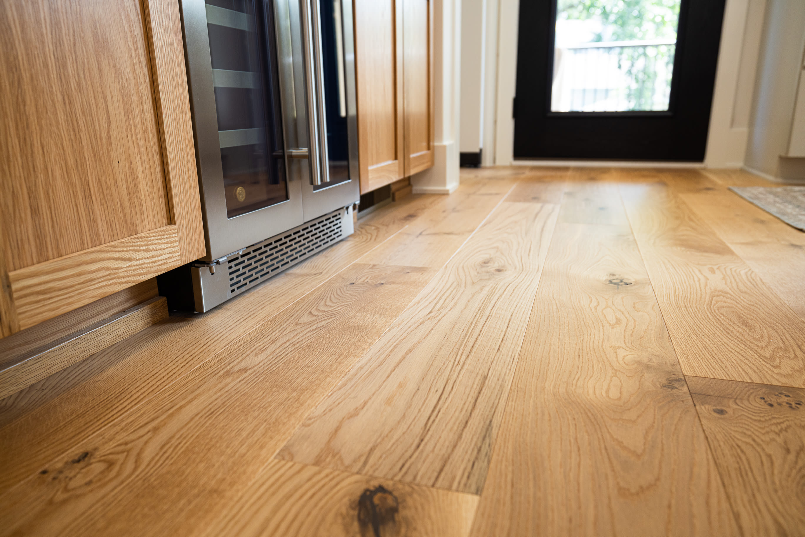 close up of white oak engineered hardwood flooring leading to doorway