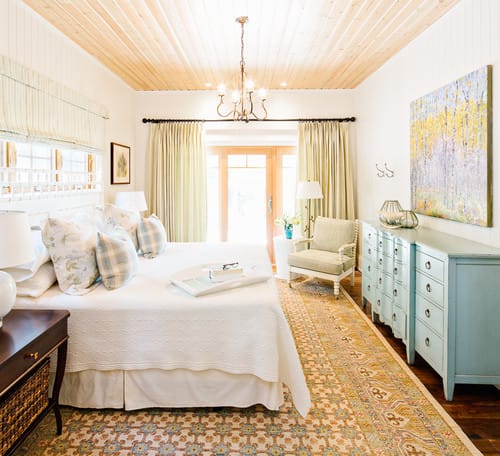 Bright bedroom is airy and natural with this wood ceiling