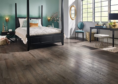 bedroom with brown hardwood flooring