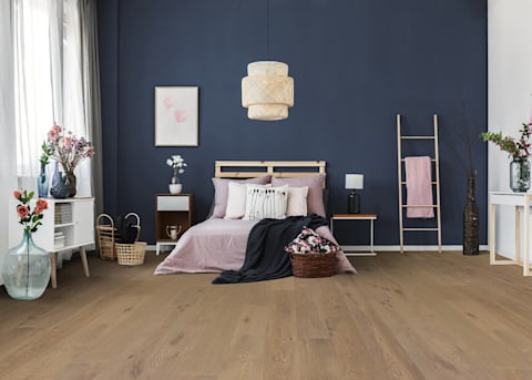 this bedroom with chandelier has a dark blue wall