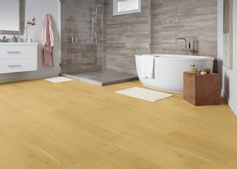 7mm+Pad x 7.48 in Lake Tahoe White Oak Water-resistant Engineered Hardwood Flooring in bathroom with freestanding oval tub and separate shower