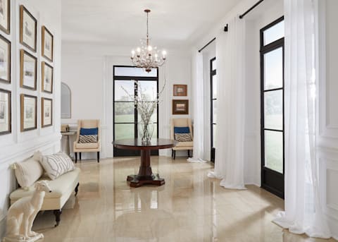 12 in x 24 in Polished Marbella Ivory Porcelain Tile Flooring in entryway with white sheer curtains, dark brown console table and cream accent chairs