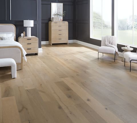 5/8 in x 9.5 in Tarpon Bay White Oak Distressed Engineered Hardwood Flooring in bedroom with black walls plus white upholstered armless chairs and blonde wood furnishings