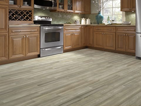 This kitchen features Avella 6 in. x 36 in. Cottage Wood Ash Porcelain Tile.