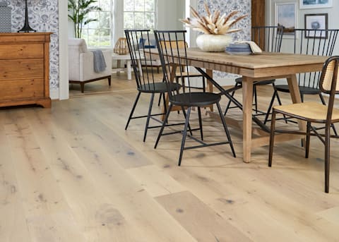 5/8 in x 9.5 in Platinum Coast White Oak Engineered Hardwood Flooring in dining room with blonde wood dining table and black spindle chairs plus blue and white wallpaper