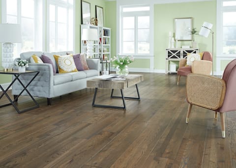 living room with light green walls and bellawood hardwood flooring