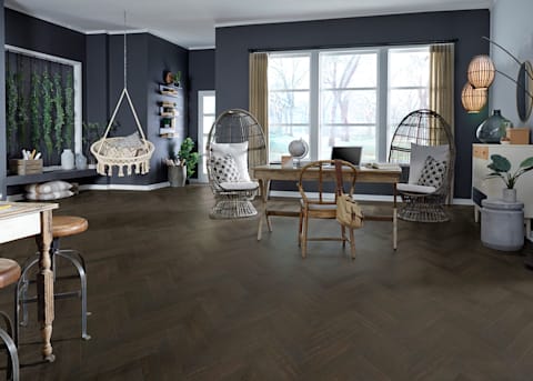 9/16 in x 4.92 Capitol Peak Chevron Engineered Hardwood Flooring in office with dark gray walls plus light wood desk and rattan egg shaped accent chairs