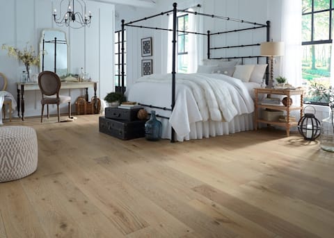 This bedroom has four-post bed, and rustic-grade Whispering Wheat Engineered Hardwood Flooring.