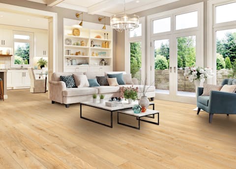 Living room with brass lighting sconces and chandelier and the realistic wood look of CoreLuxe XD 5mm w/pad Cardiff Red Oak Rigid Vinyl Plank Flooring.