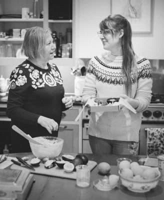 Claire and Mo conversing in the kitchen