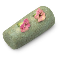 a green cleanser made from sugar with fresh flowers on top
