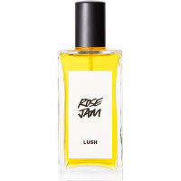 A bottle of Rose Jam Lush perfume. The perfume is golden yellow in colour and contained in a rectangle bottle featuring a black lid and white label.