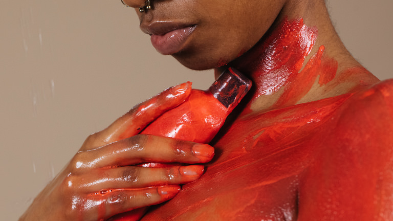 Ginger Naked Shower Gel mold lathers in bright red naked shower gel into shoulder