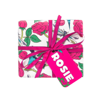 Rosie Gift A square gift with pink toned floral wrapping paper, a pink ribbon and a pink tag that reads 'Rosie Gift'.
