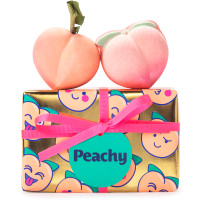 golden wrapped present with peach illustrations and products on top 