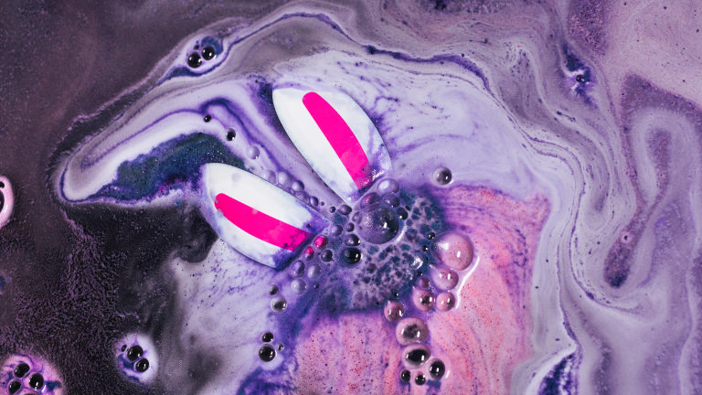 Magic Rabbit Bath Bomb bunny ears engulfed in foamy grey and pink bath water
