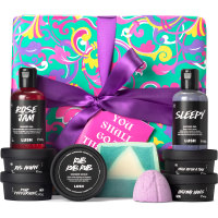 You Shall Go To The Ball Gift green gift box with pink and purple patterns on it with christmas gifts inside and around it