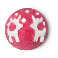 A red bath bomb with white reindeers patterns on the top