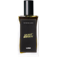 Lush 100ml Secret Garden Perfume A bottle of Secret Garden Lush perfume. The perfume is dark brown in colour and contained in a rectangle bottle featuring a black lid and label.