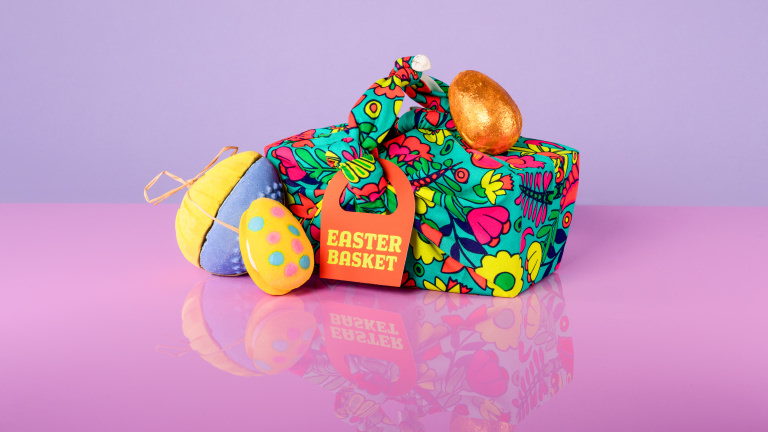 Easter Basket Gift basket gift covered in green nature themed material with products surrounding it