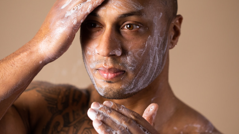 Fresh Farmacy A man with shaved head washing his face