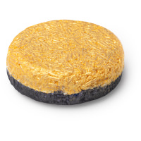 circular shampoo bar with black coloured bottom and yellow coloured top