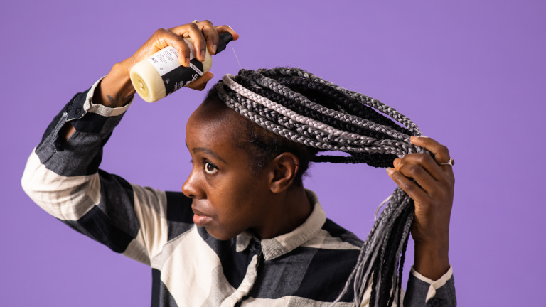 Super Milk a spray on conditioner being used in hair
