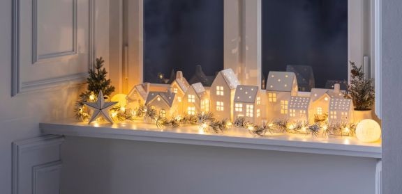Fensterbank dekoriert mit verschiedenen Lichthäusern.