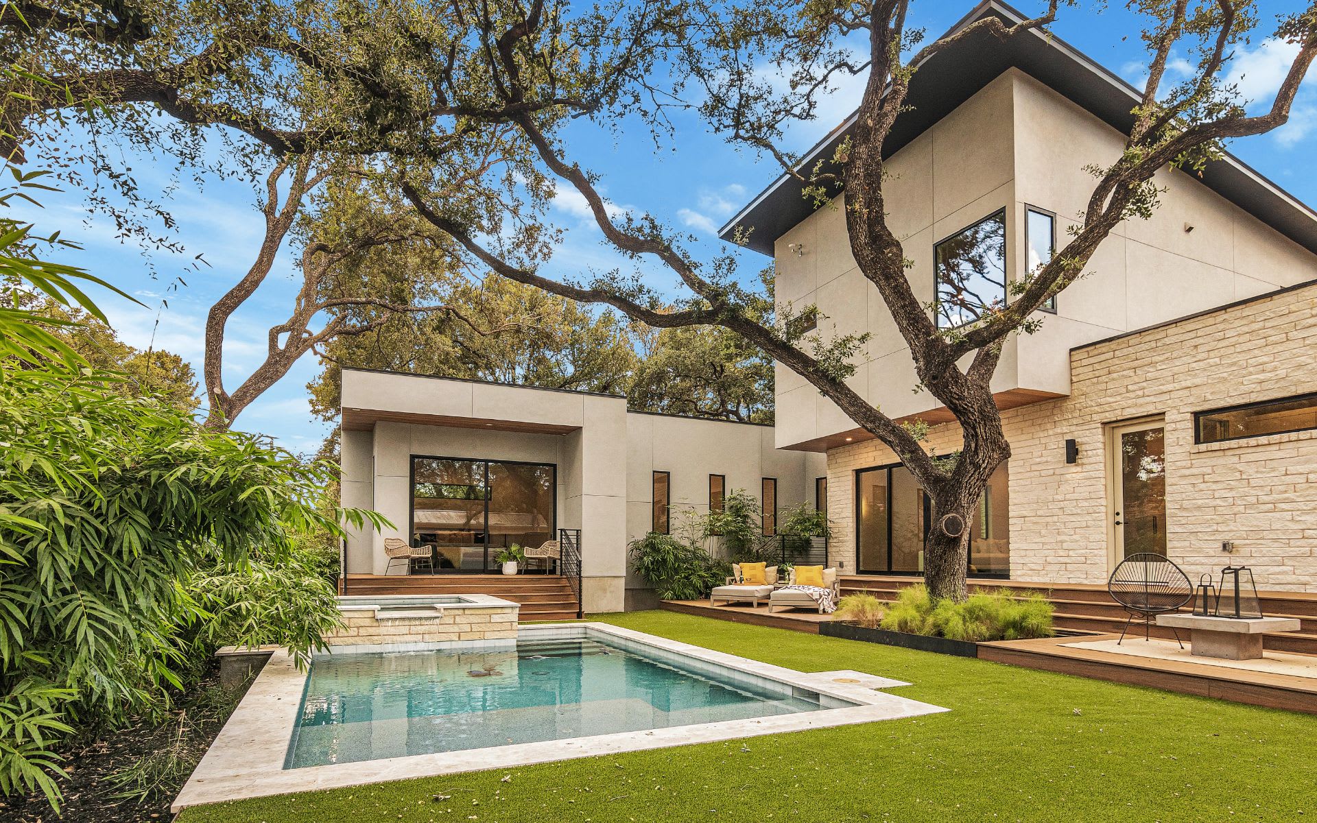 A modern house with a swimming pool and a deck in the backyard