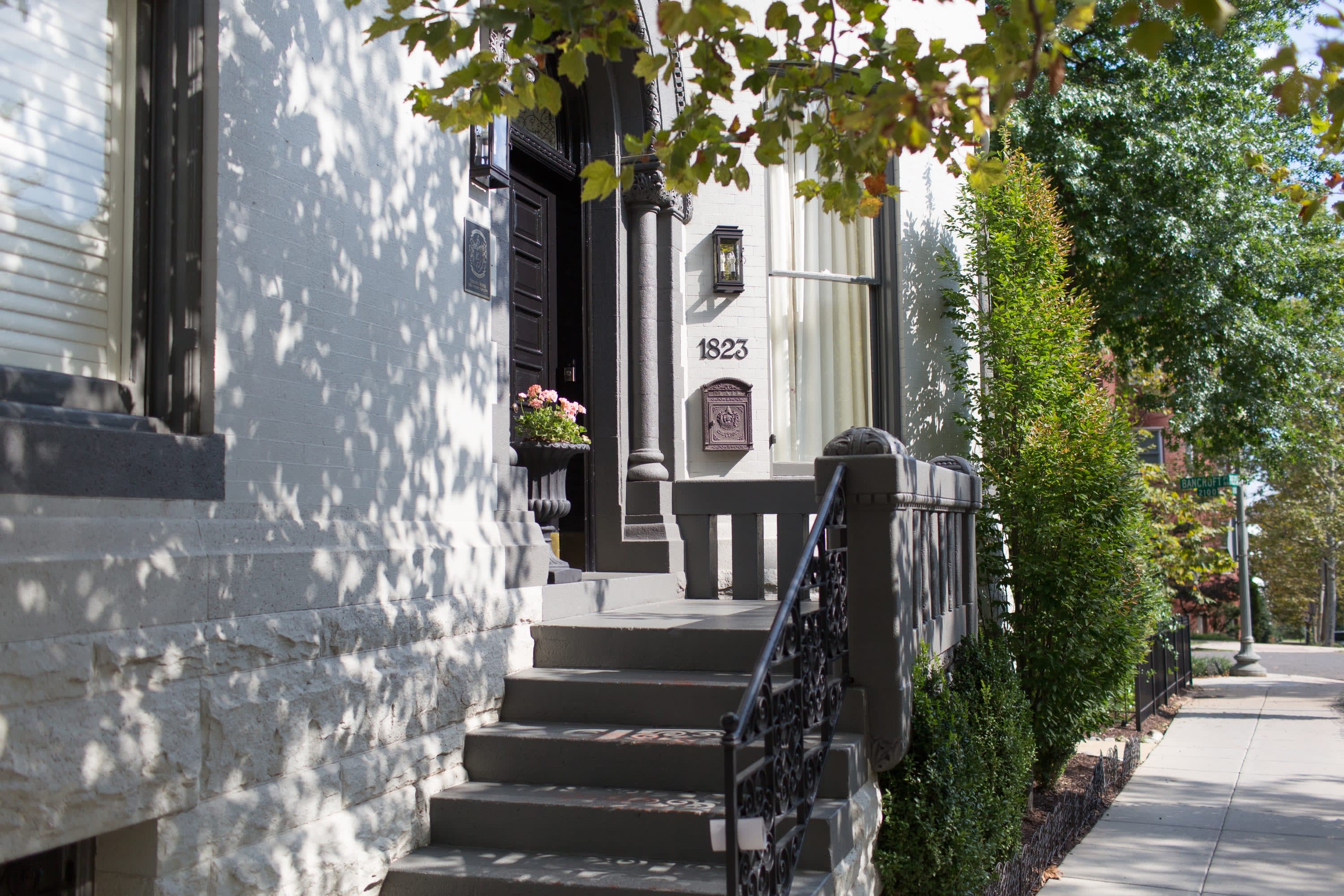 A white building with a grand staircase leading up to the front door