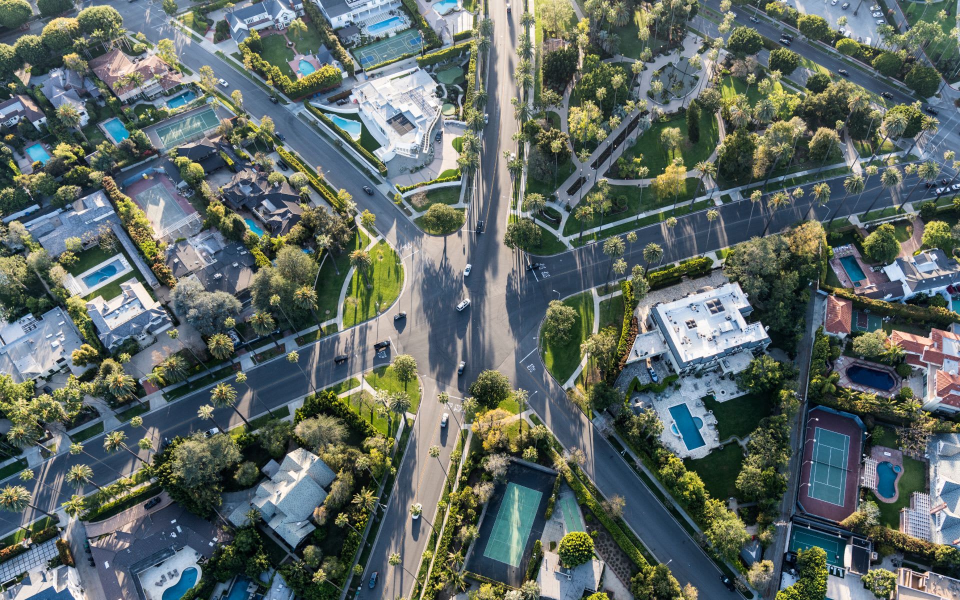 A tranquil suburban neighborhood with single-family homes, lush greenery, and a central park