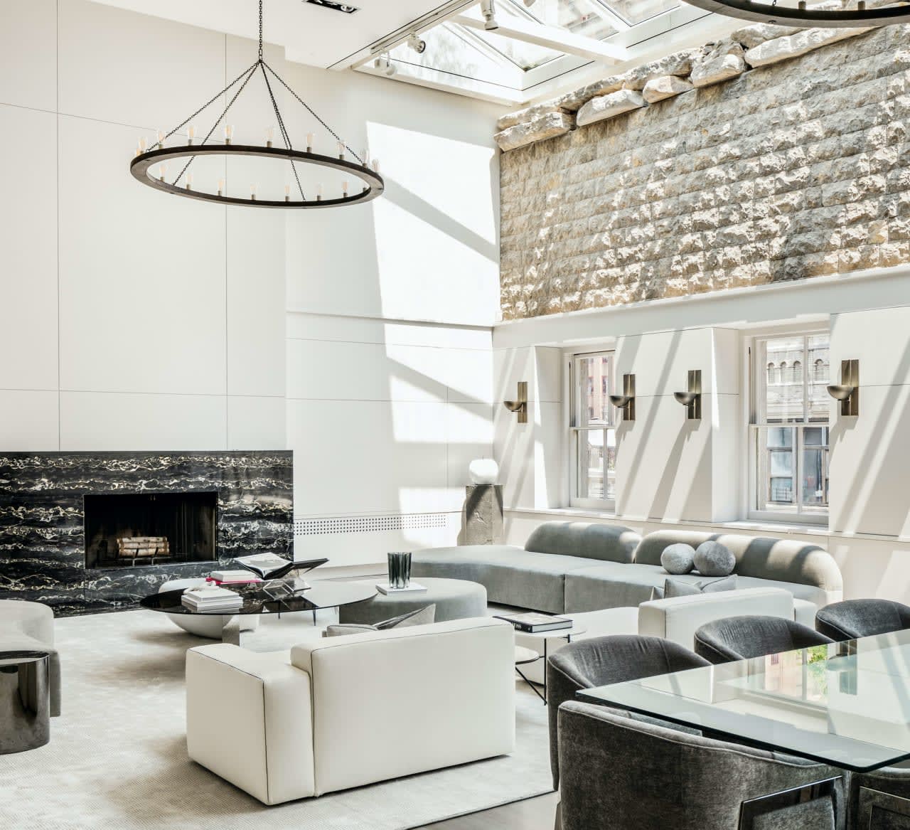 A living room with a fireplace, couch, chairs, and a coffee table