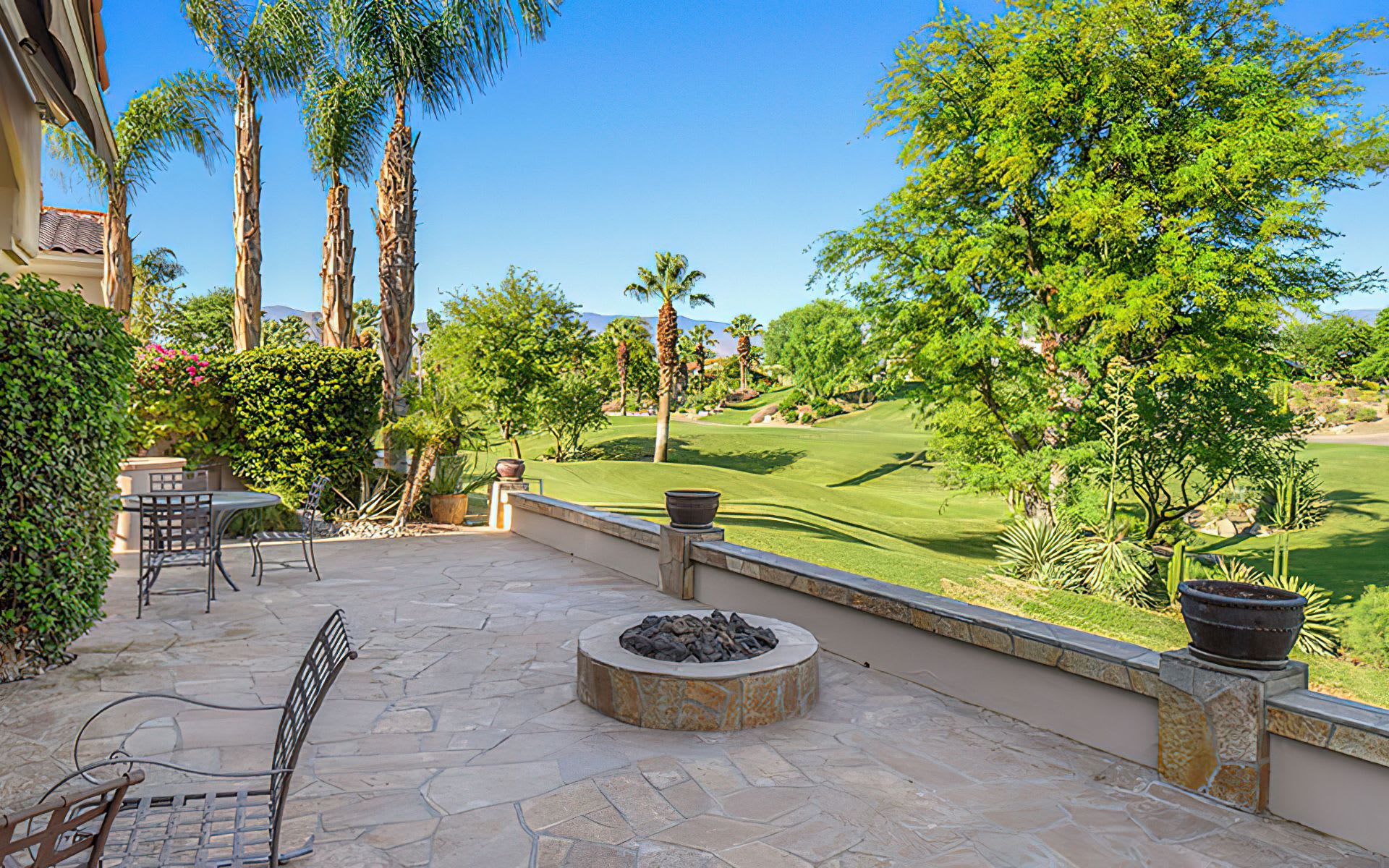 An inviting outdoor retreat with fire pit overlooking a golf course