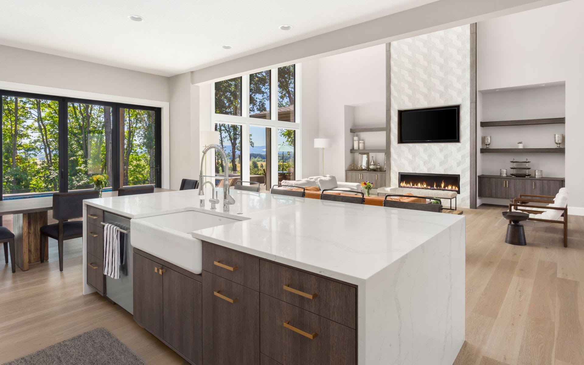 A modern kitchen with sleek white cabinets, stainless steel appliances, and a light wood countertop