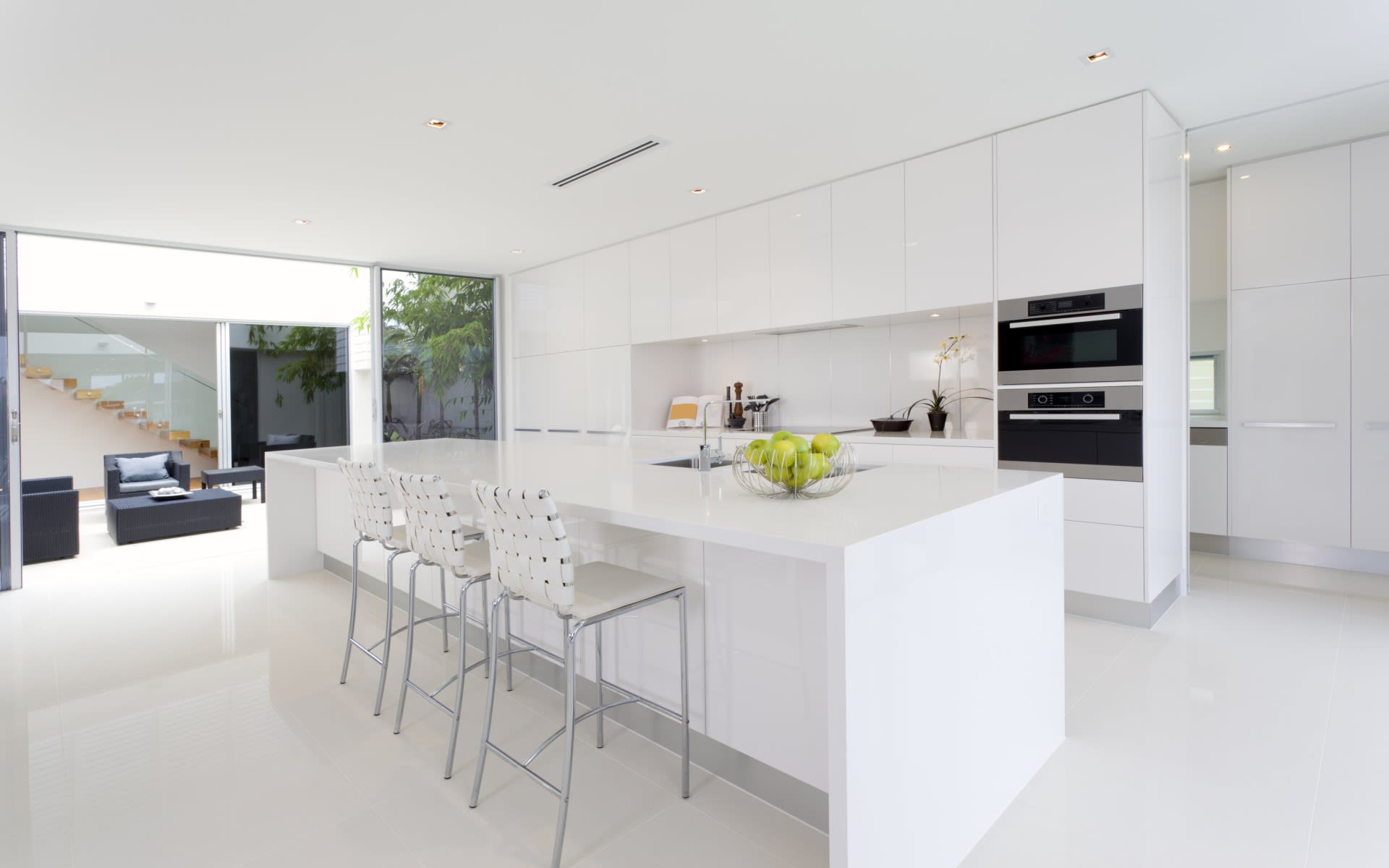Modern kitchen with sleek white cabinets and a large island