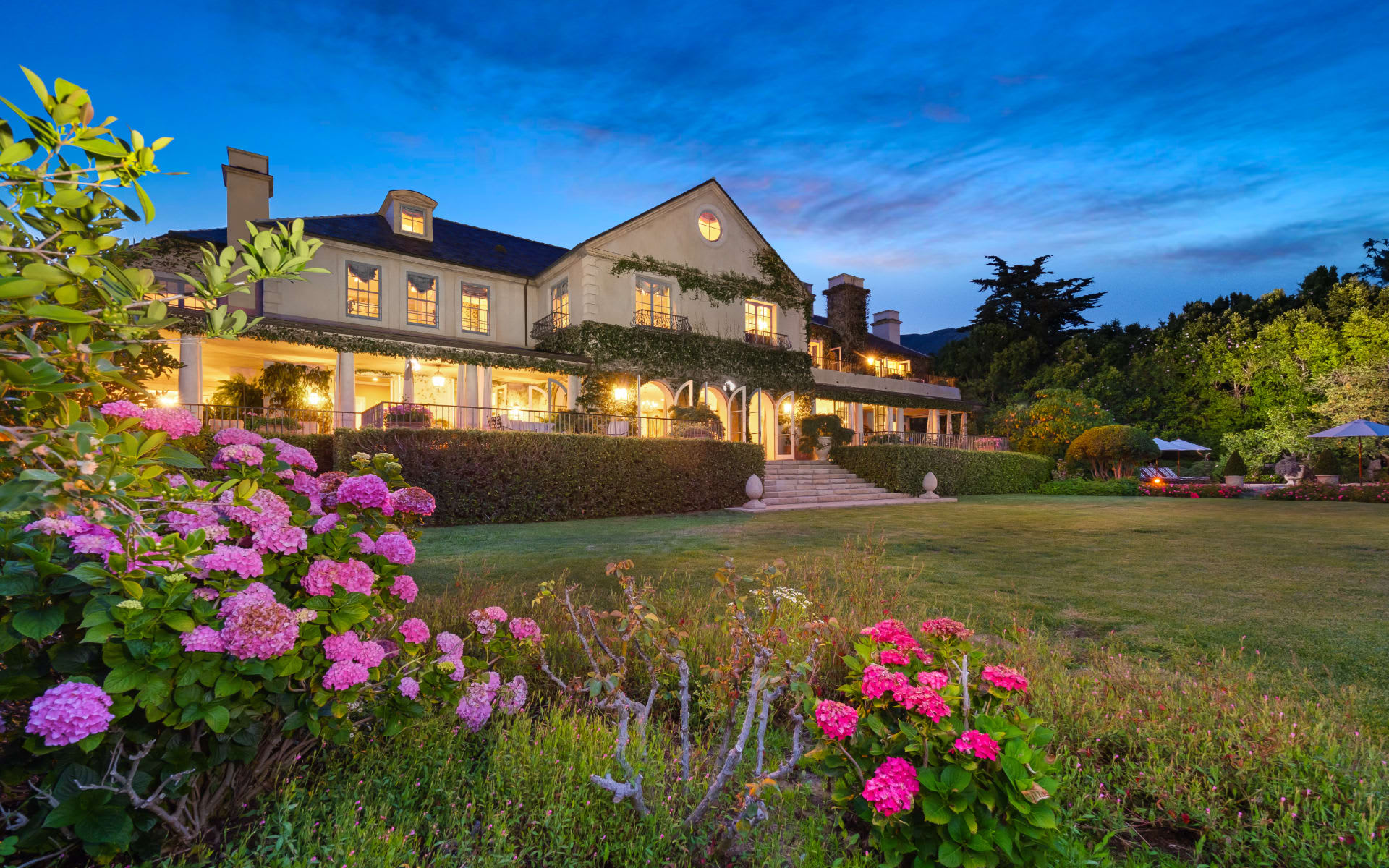 A large house sitting on top of a lush green field