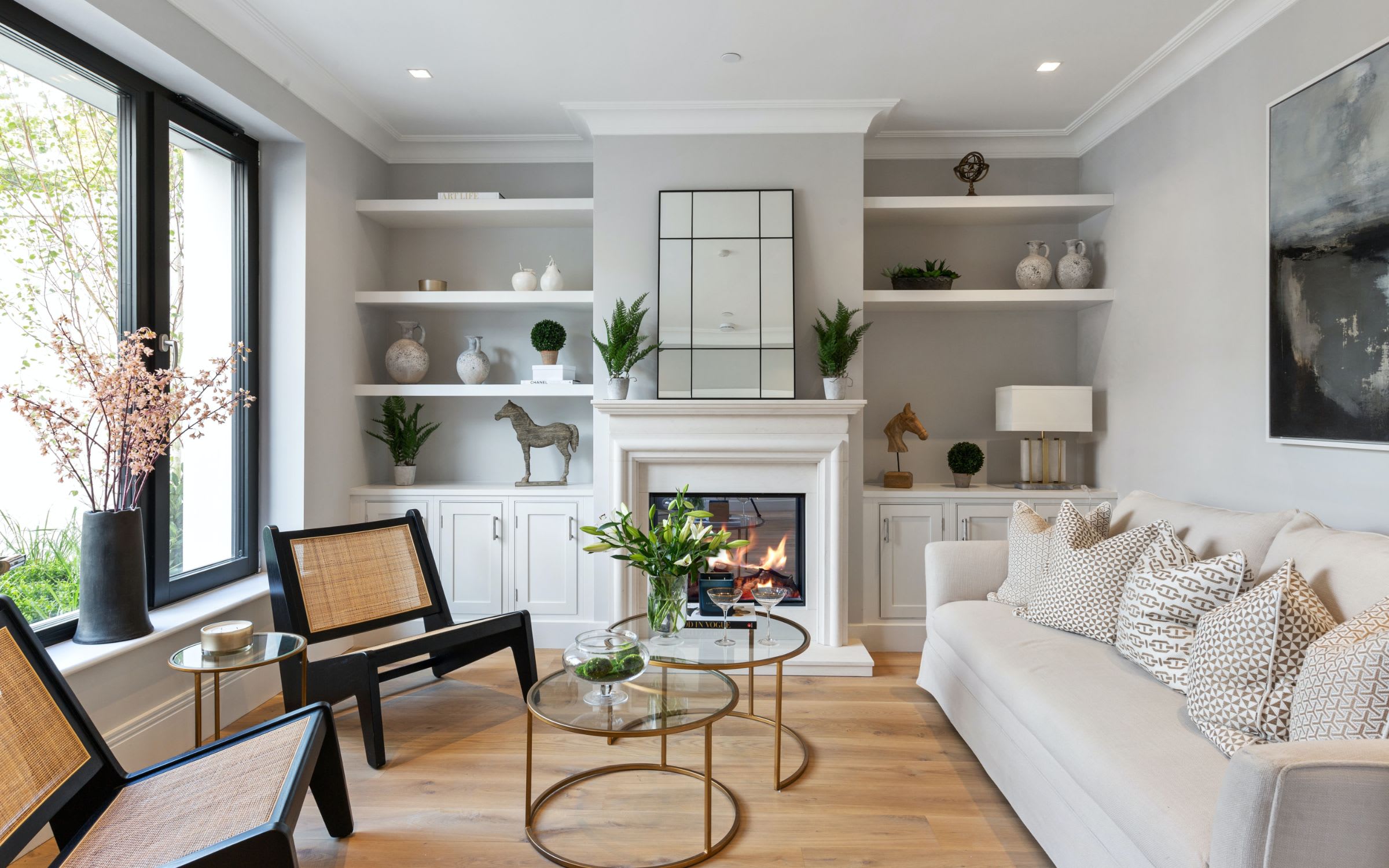  A cozy living room with white walls and a white fireplace