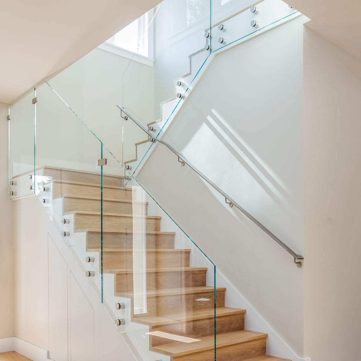 an image of a modern staircase with glass handles