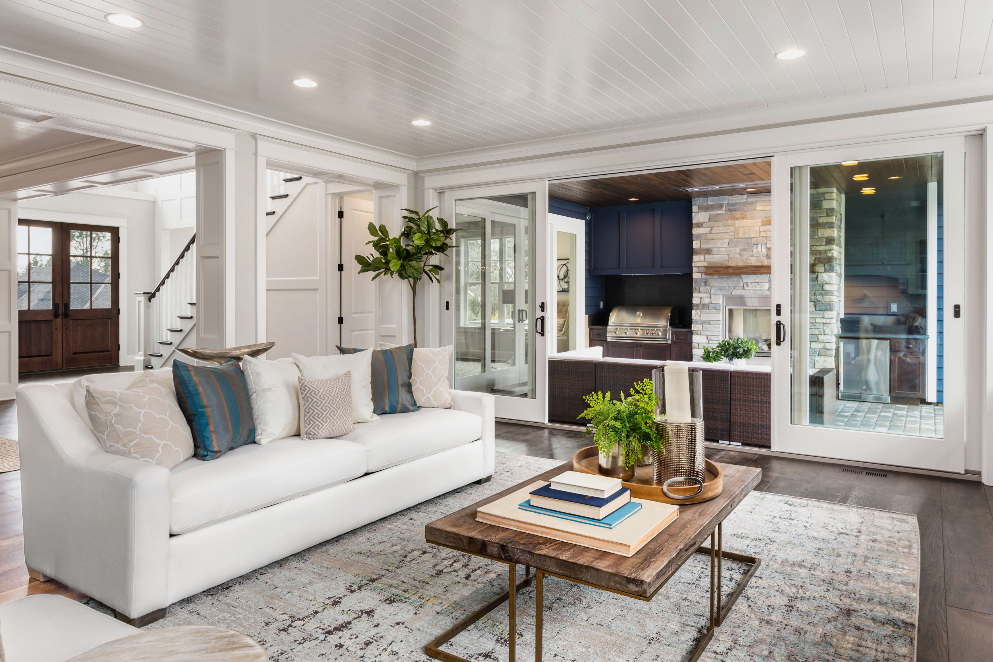 A living room with a couch, coffee table, and sliding glass doors.