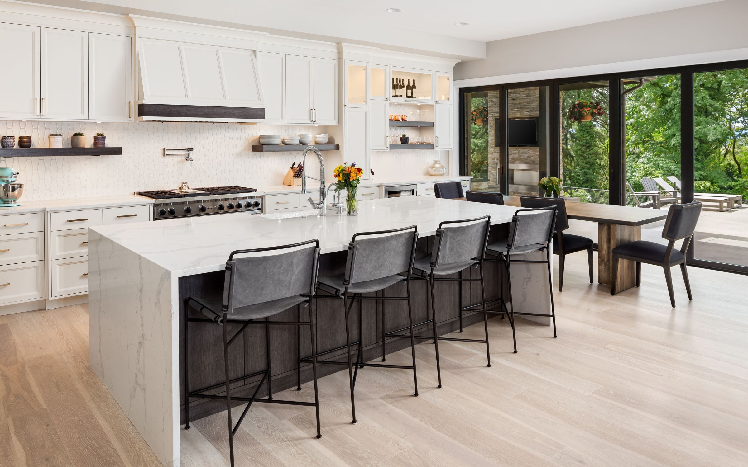 A kitchen with wooden cabinets, black granite countertops, and stainless steel appliances.